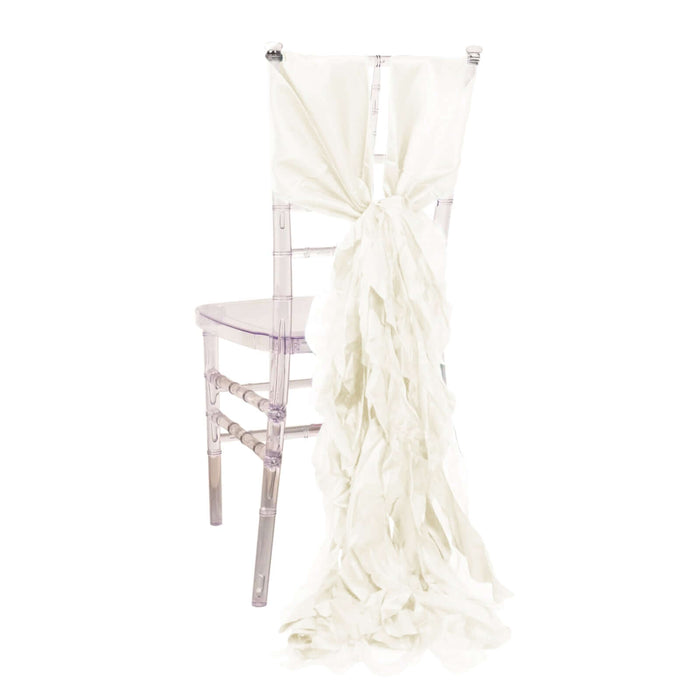 White fabric chair sash tied in a bow on a clear chiavari chair.