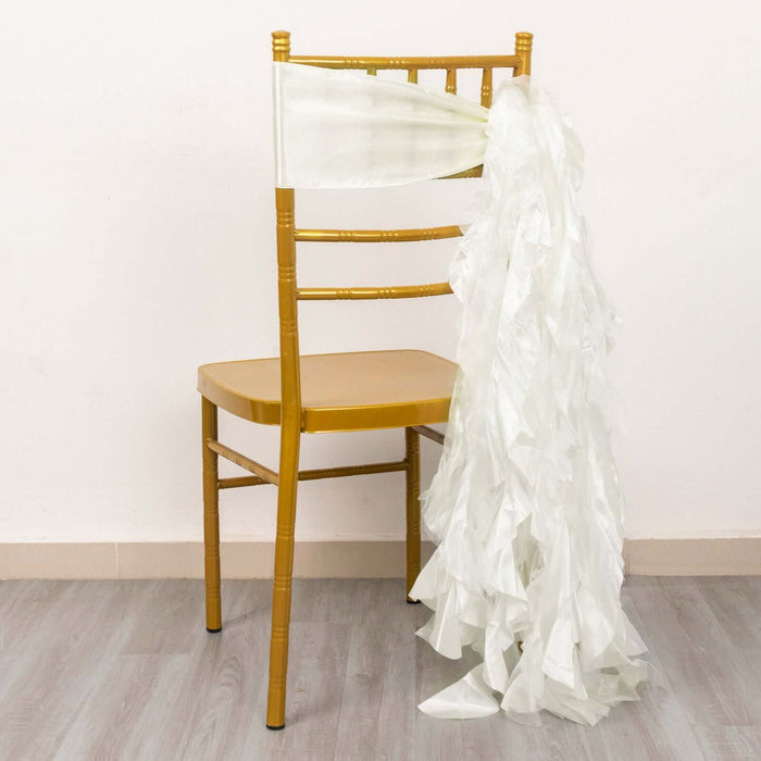 Gold chiavari chair with white ruffled chair sash draped over the back.