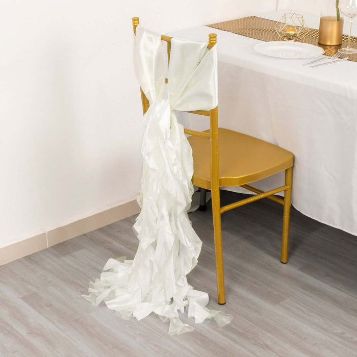 Elegant white chair sash draped on a gold chair at a dining table.