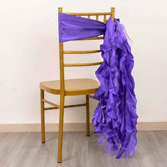 Purple ruffled chair sash draped on a gold chair against a plain backdrop.
