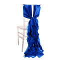 Blue satin chair sash draping elegantly down a clear chair.