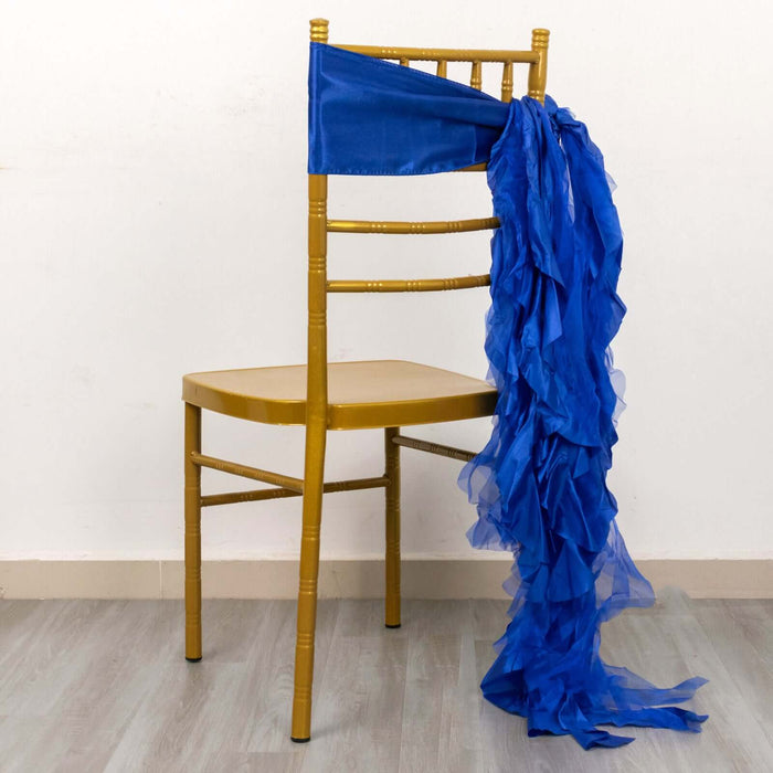 Blue ruffled chair sash draped over a gold chiavari chair.