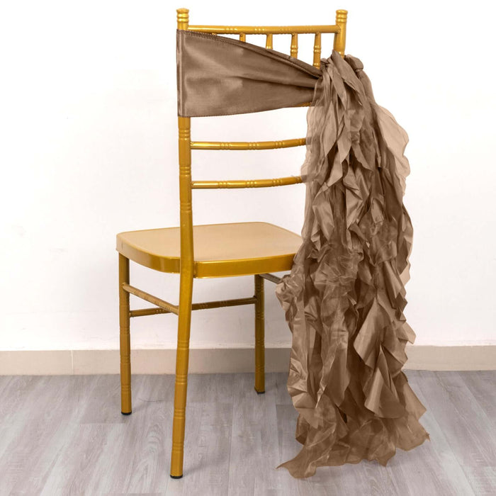 Gold chiavari chair with a brown ruffled sash draped over the back.