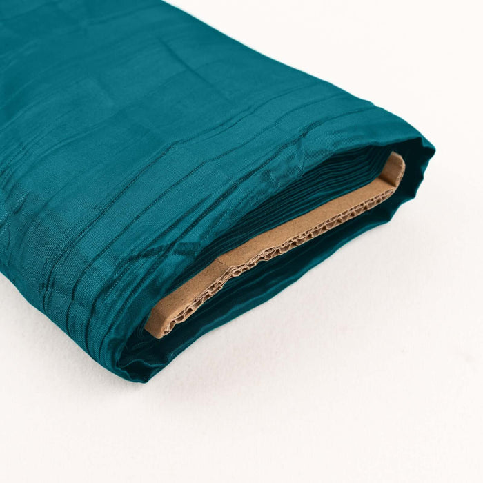 Teal fabric roll with textured finish on a plain background