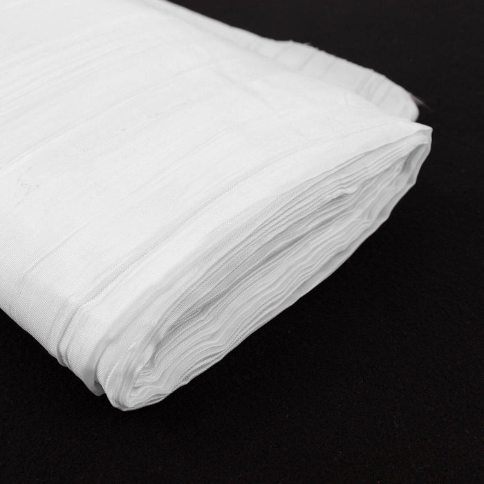 White fabric roll on a dark background.