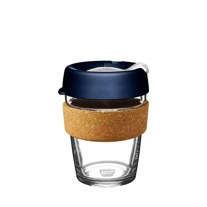 KeepCup Brew Cork in Spruce, medium 12oz size, featuring a clear glass cup with natural cork band and deep navy blue lid with sipper closure, shown against a white background.
