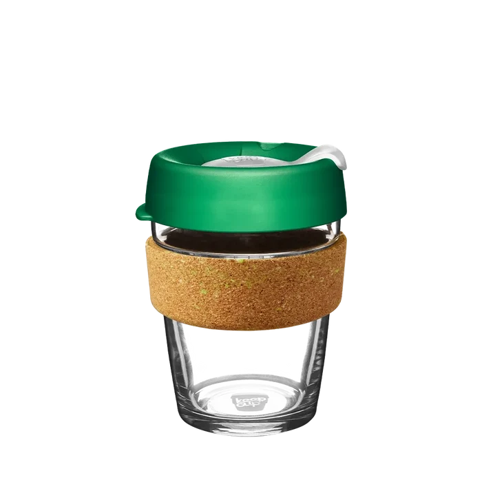 KeepCup Brew Cork Ace in size M 12oz, featuring a clear tempered glass cup with a natural cork band and green plastic lid with sip hole closure, shown against a white background.