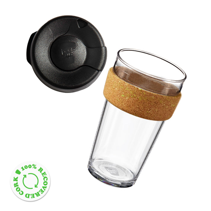 KeepCup Brew Cork Ace L 16oz reusable coffee cup shown from above at an angle, featuring a clear glass cup with a natural cork band and black lid placed separately beside it. A green badge indicates the cork is 100% recovered.