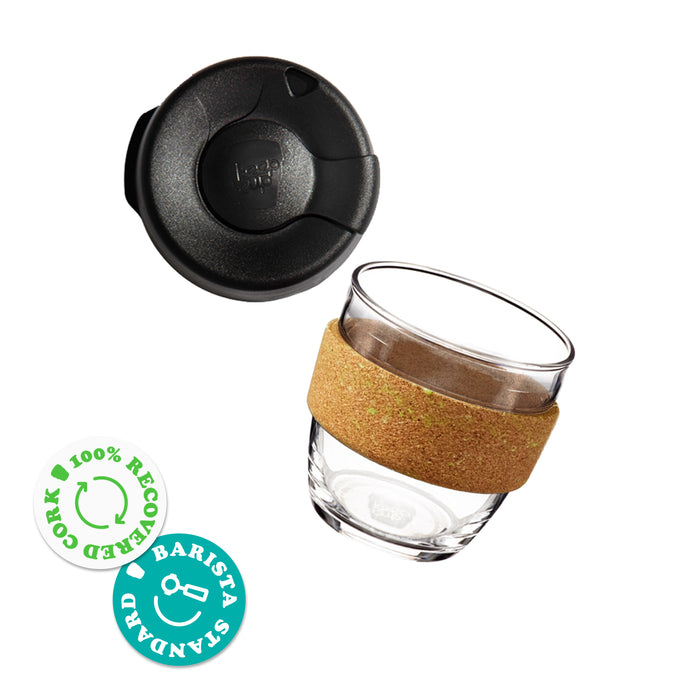 KeepCup Brew Cork Ace S 8oz, shown as an exploded view with the black lid separated from the clear glass cup featuring a natural cork band. Two badges indicate 100% recovered cork and barista standard sizing.