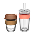 KeepCup Booked & Busy Frappe set featuring two reusable cups: a glass coffee cup with cork band and brown lid alongside a larger clear tumbler with coral-coloured silicone band and straw, shown against a white background.
