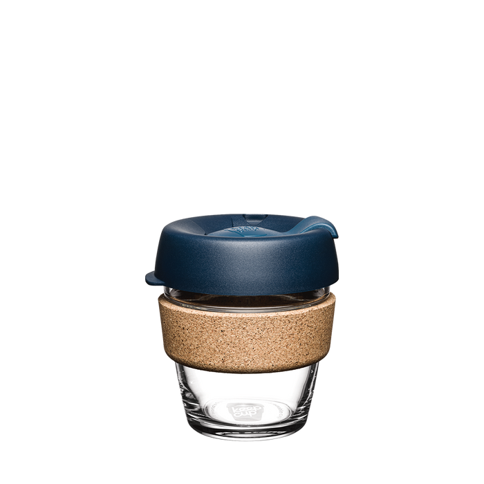 KeepCup Brew Cork XS 6oz in Spruce, featuring a clear glass cup with natural cork band and deep blue lid, shown against a plain white background.