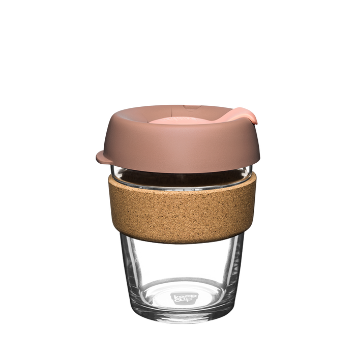 KeepCup Brew Cork M 12oz in Frappe, featuring a clear tempered glass cup with natural cork band and dusty pink silicone lid with sipper, shown from a front angle against a white background.