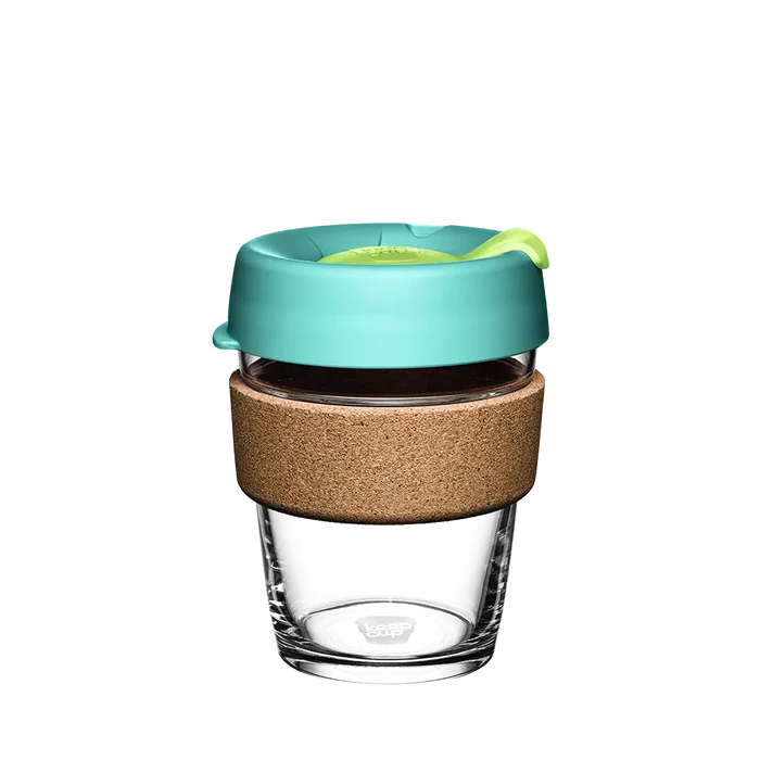 KeepCup Brew Cork M 12oz in Matcha, featuring a clear glass cup with natural cork band and teal silicone lid with lime green plug, shown against a white background.