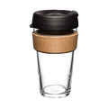 KeepCup Brew Cork L 16oz in Black, shown from a front angle against a white background, featuring a clear tempered glass cup, natural cork band, and black plastic lid with sipper opening.
