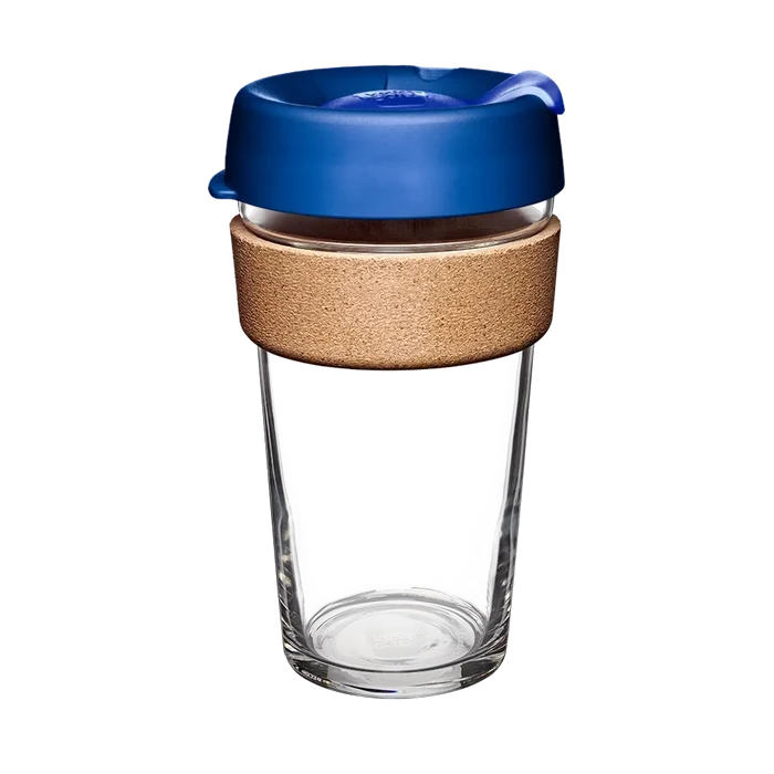 KeepCup Brew Cork L 16oz in Electric Blue, shown against a white background. The reusable cup features a clear glass body, natural cork band for heat protection, and a blue plastic lid with sip-through opening.