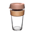 KeepCup Brew Cork L 16oz in Frappe colour, featuring a clear tempered glass cup with natural cork band and dusty pink silicone lid with sipper opening, shown on a plain white background.
