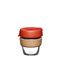 KeepCup Brew Cork XS 6oz in Daybreak colour, featuring a clear glass cup with natural cork band and warm orange-red lid with sipper closure, shown against a plain white background.