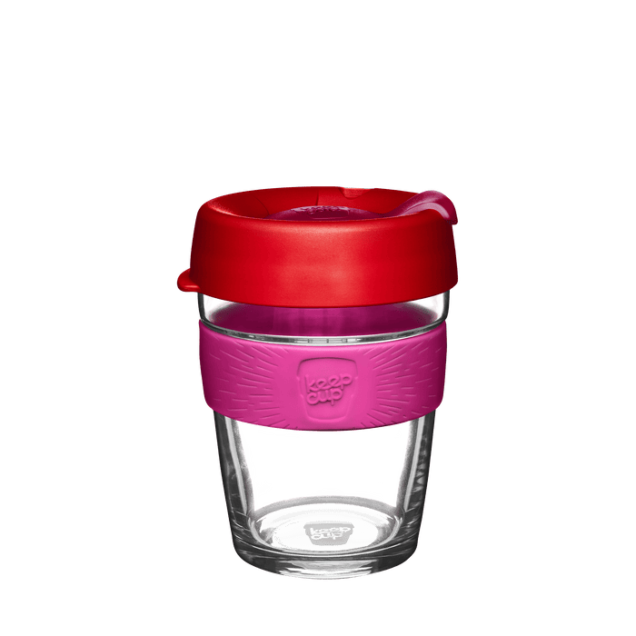 KeepCup reusable glass coffee cup with red lid, pink silicone band and clear glass body on white background