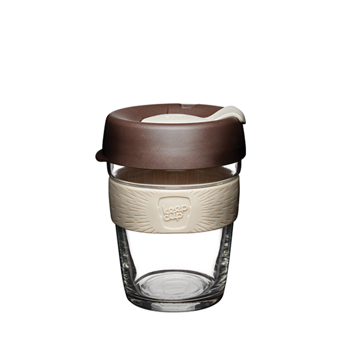 KeepCup Brew M 12oz in Roast, featuring a clear glass cup with a cream-coloured silicone band and brown plastic lid with sip hole, shown against a white background.