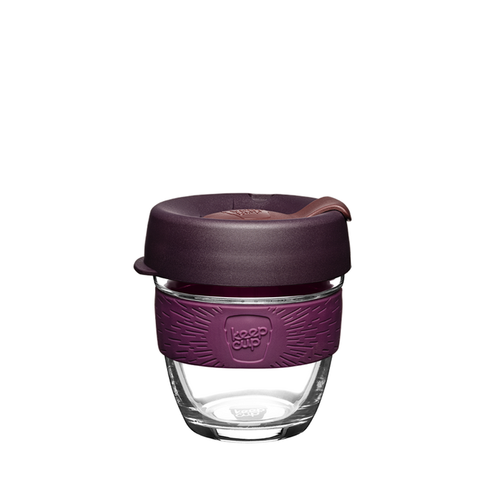 KeepCup Brew S 8oz in Alder colour, featuring a clear tempered glass cup with a deep plum silicone band embossed with the KeepCup logo, and a dark aubergine press-fit lid with a mauve-toned plug, shown against a plain white background.