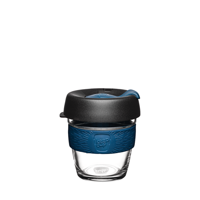 KeepCup Brew XS 6oz in Oxford Blue, featuring a clear glass cup with a navy blue silicone band and charcoal lid with matching blue plug, shown against a plain white background.