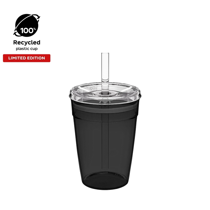 Cold Cup Original M 12oz in Recycled Black, shown from a front angle against a white background, featuring a translucent black cup body, clear lid with straw hole, and clear reusable straw. Limited edition badge and 100% recycled plastic cup icon displayed in top left corner.