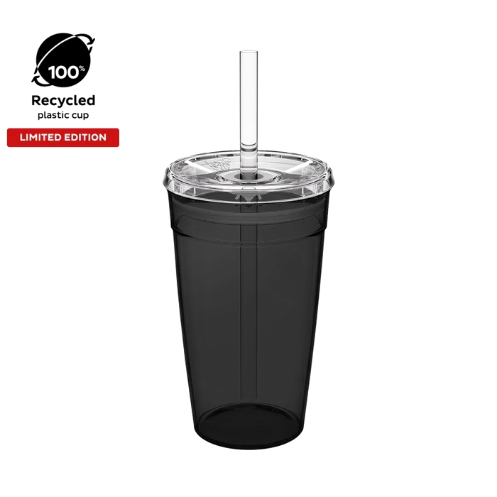 Cold Cup Original L 16oz in Recycled Black, shown from a front angle against a white background, featuring a translucent black cup body, clear lid with straw hole, and clear reusable straw. Badges indicate 100% recycled plastic cup and limited edition.