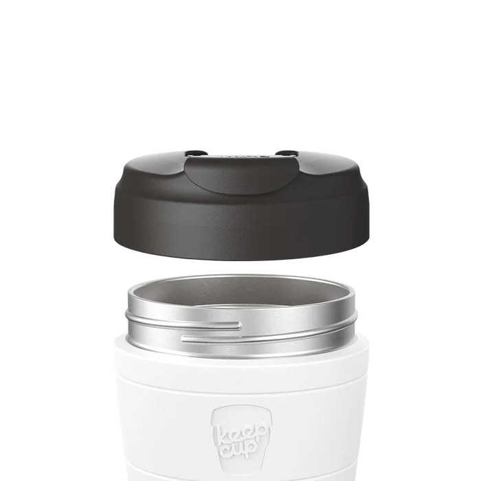 Exploded view showing the Commuter Flip Lid in Black hovering above a white KeepCup with stainless steel rim, demonstrating how the lid attaches to the cup.