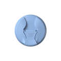 Top-down view of the Commuter Flip Lid in Orchid, showing the circular light blue lid with its distinctive flip-open drinking spout in the closed position, featuring the embossed KeepCup logo in the centre.