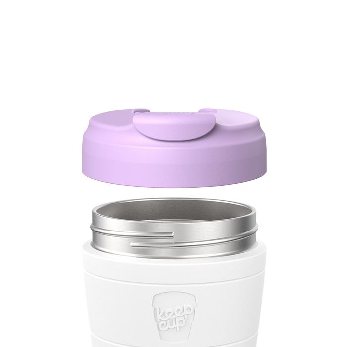 KeepCup Commuter Flip Lid in Wisteria shown lifted above a white reusable cup with stainless steel rim, displaying how the lavender-coloured lid attaches to the cup.