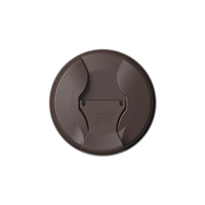 Top-down view of the KeepCup Commuter Flip Lid in The Force, a dark brown colour, showing the closed sipper with the embossed KeepCup logo on the flip tab.