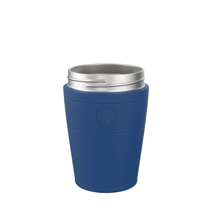 KeepCup Helix Stainless Steel Base in Cobalt, M 12oz size, shown from a front angle against a plain white background. The reusable cup features a deep blue sleeve with embossed KeepCup logo and a silver stainless steel rim.