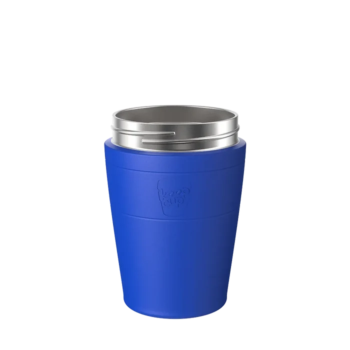 KeepCup Helix Stainless Steel Base in Electric Blue, M 12oz size, shown from a front angle against a white background, featuring the embossed KeepCup logo on the vibrant blue exterior and stainless steel rim.