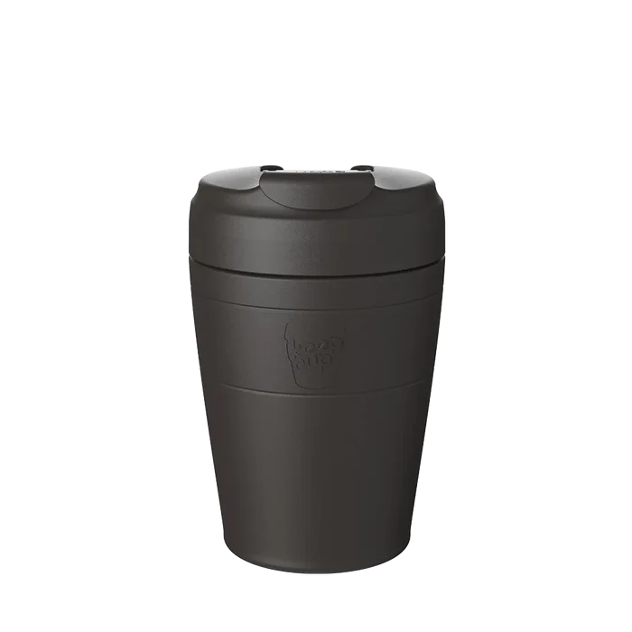 KeepCup Commuter M 12oz in Black, shown in a front-facing studio shot displaying the matte black reusable cup with flip-top lid and embossed KeepCup logo on the cup base.