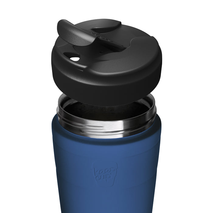 Close-up of a blue KeepCup insulated travel mug with a black flip lid, shown on a plain white background.