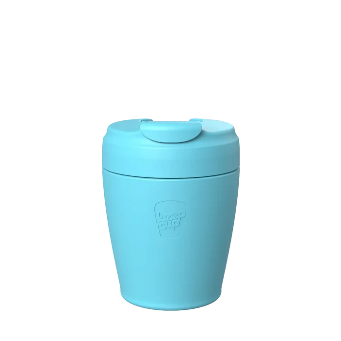KeepCup Commuter S 8oz in Cloud, a light blue reusable coffee cup with matching lid featuring a flip-top drinking closure, shown against a white background with the embossed KeepCup logo visible on the cup body.