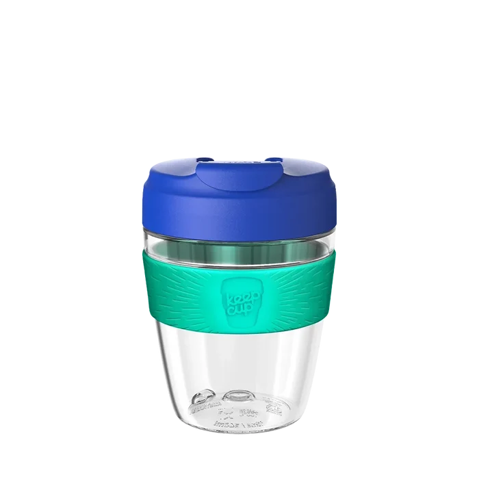 KeepCup Commuter Light M 12oz in Electric Frost, featuring a clear lightweight plastic cup with turquoise silicone band and navy blue lid with sipper closure, shown against a white background.