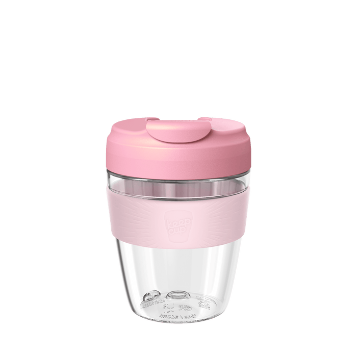 KeepCup Commuter Light M 12oz in Pashmak Pink, featuring a clear lightweight plastic cup with a soft pink silicone band and matching pink lid with sipper closure, shown against a white background.
