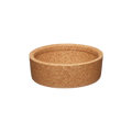 Cork Band for KeepCup Glass XS, shown from a slight angle against a white background, displaying the natural cork material's speckled tan texture and shallow cylindrical shape.
