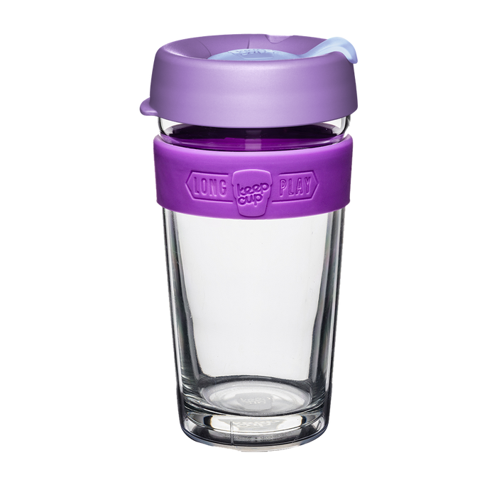 KeepCup Brew Longplay in Helio, 16oz reusable coffee cup featuring a clear double-walled glass body, purple silicone band with embossed branding, and lavender lid with light blue sipper, shown against a white background.