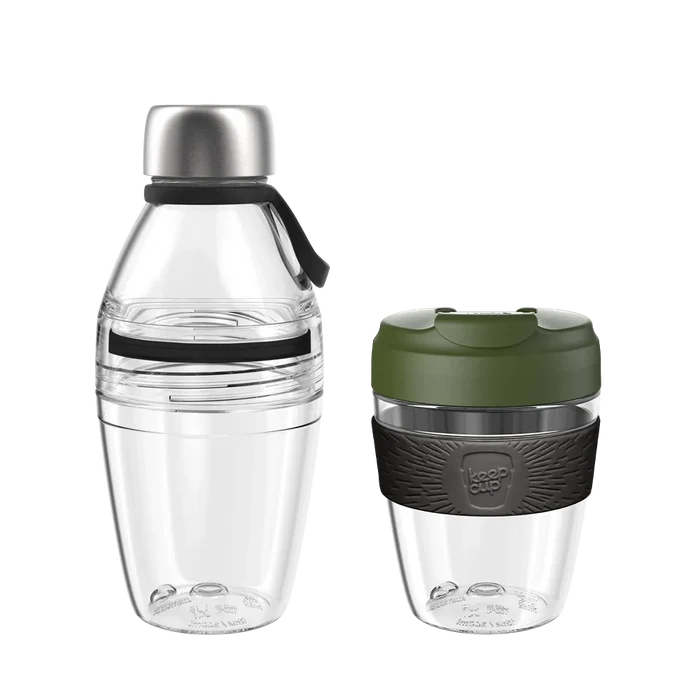 KeepCup Glow Getter Pine set featuring a clear reusable water bottle with stainless steel cap and black carry loop alongside a clear reusable coffee cup with olive green lid and charcoal grey band, shown against a white background.