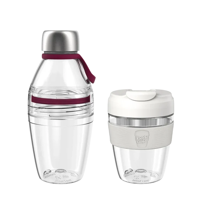 KeepCup Glow Getter set in Burgundy featuring a clear reusable water bottle with stainless steel cap and burgundy silicone accents alongside a clear reusable coffee cup with white lid and light grey band, both shown on a plain white background.