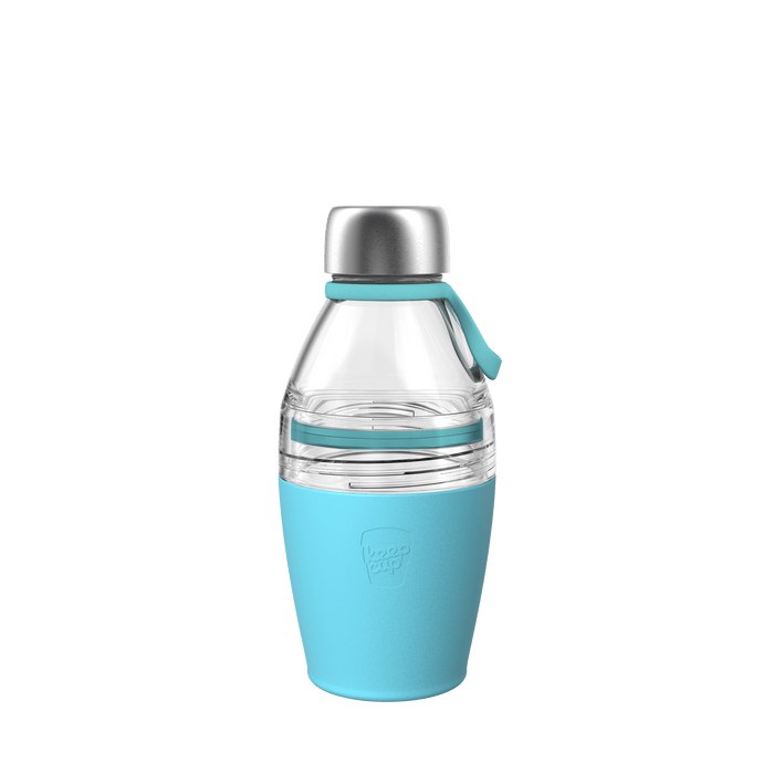 KeepCup Helix Bottle Clear Top in Cloud, 420ml, shown against a white background featuring a clear glass upper section, stainless steel cap, and light blue silicone band and base with the KeepCup logo embossed.