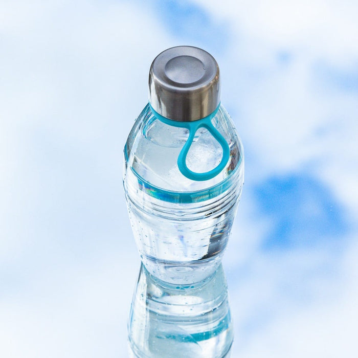 KeepCup Helix Light Bottle 530ml in Cloud, a clear reusable water bottle with silver stainless steel cap and teal carrying loop, shown at a slight angle against a soft blue background with visible water inside.