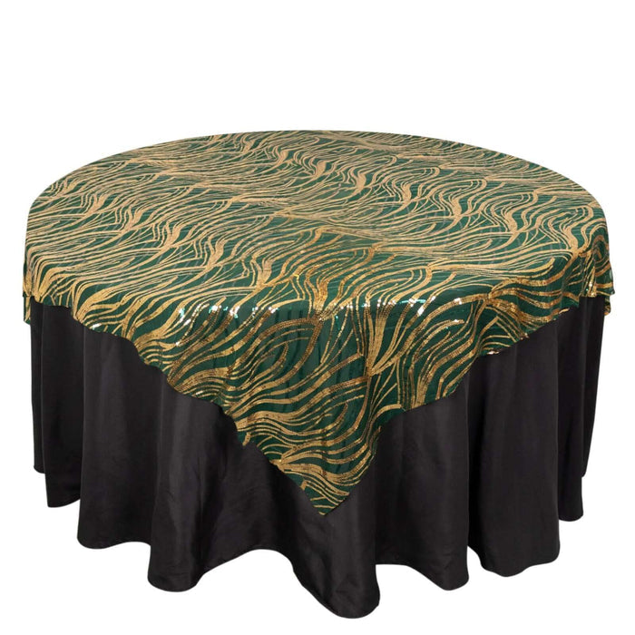 Decorative green and gold tablecloth on a black table.