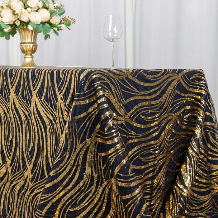 Gold and black sequined tablecloth draped over a table with a floral centerpiece.