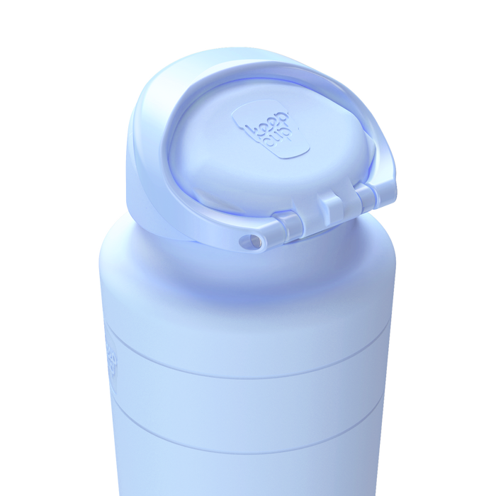 KeepCup Ora Bottle in Orchid, 700ml, shown in light periwinkle blue with the flip-top lid open, highlighting the drinking spout and embossed KeepCup logo on the lid.