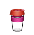 KeepCup Original Clear M 12oz in Daybreak, featuring a clear plastic cup with a bright pink silicone band and coral-coloured lid with sipper closure, shown against a white background.