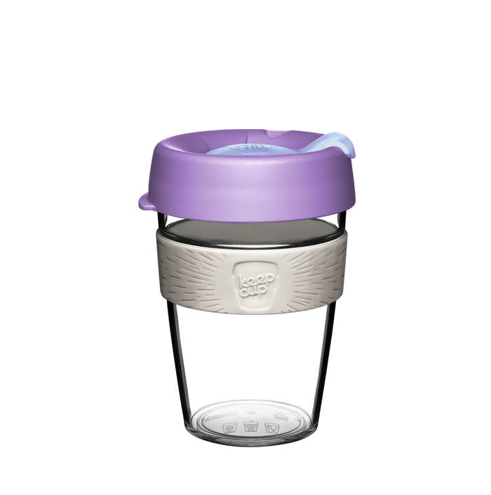 KeepCup Original Clear M 12oz in Moonshine, featuring a transparent reusable cup with lavender purple lid, light grey silicone band embossed with the KeepCup logo, and clear plastic body, shown against a white background.