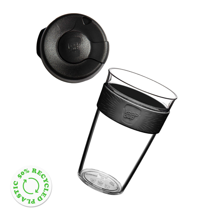 KeepCup Original Clear L 16oz shown as an exploded view with the lid floating above the clear plastic reusable cup featuring a silicone band with the KeepCup logo. A green 50% recycled plastic badge appears in the corner.
